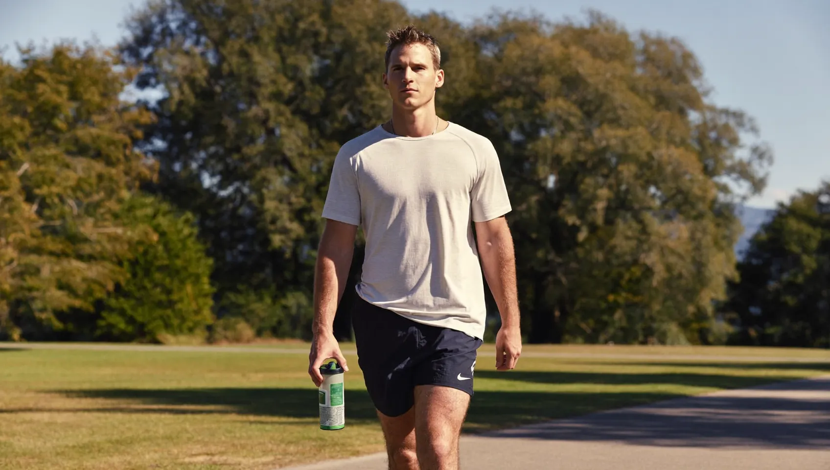 Man taking an easy recovery walk outdoors on a rest day instead of training hard